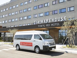 A white van parked in front of The Warehouse Tokyo Rei Hotel. - The HOTEL Well-hub Haneda (Formerly: Kawasaki King Skyfront Tokyu REI Hotel) (Kawasaki)