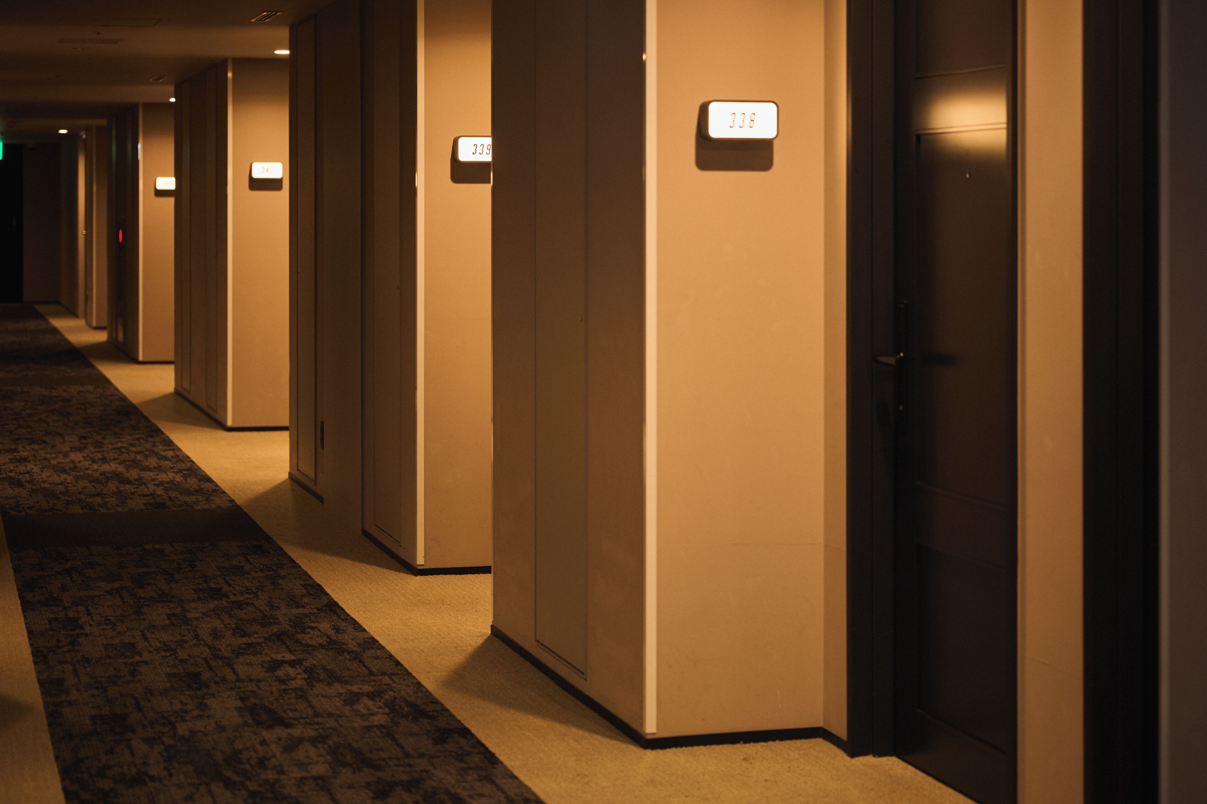 A hotel corridor with doors numbered 337 to 338.