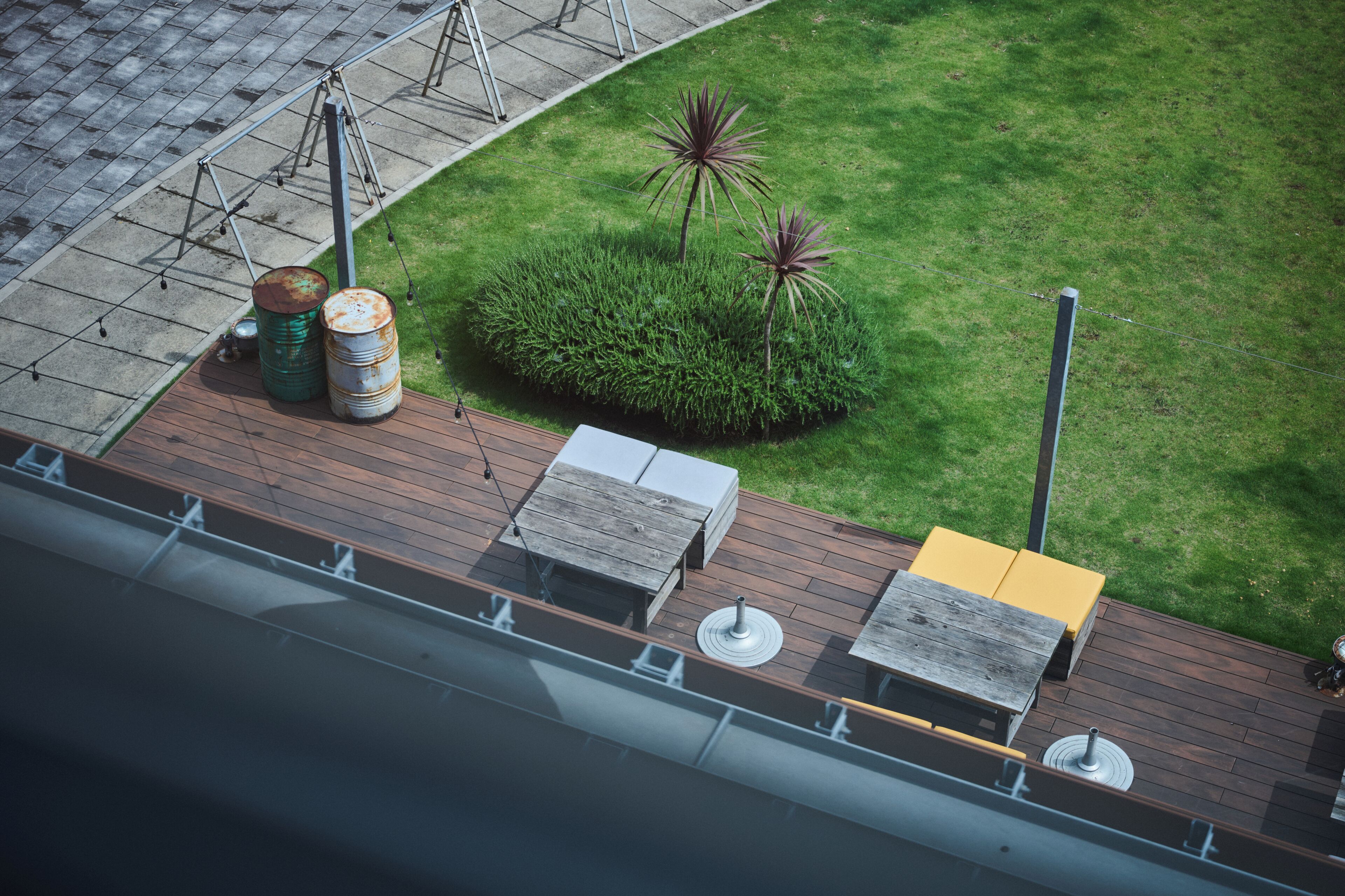 An outdoor seating area with a wooden deck, a small table, and two chairs.