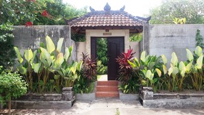 A traditional gate with a tiled roof, leading to a building with a sign reading "Villa Seruling". - Vantage Point Villas (Ungasan)