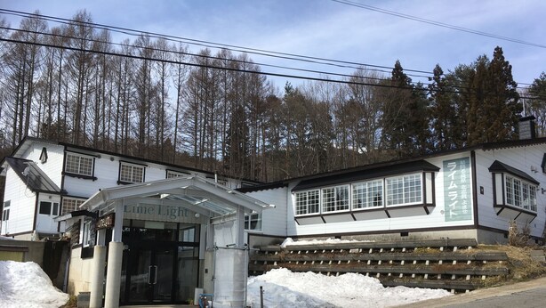 A building with a sign reading "Lime Light" and another sign in a foreign language. - Kitashiga Lime Light (Yamanouchi)