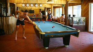 A pool table in a room with wooden walls and a tiled floor. - Cat Ba Sisters Legend Cruise (Hai Phong)