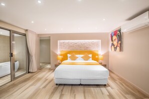 A modern bedroom with a large bed, a glass shower enclosure, and a painting on the wall. - Villa Mai Tai (Koh Samui)