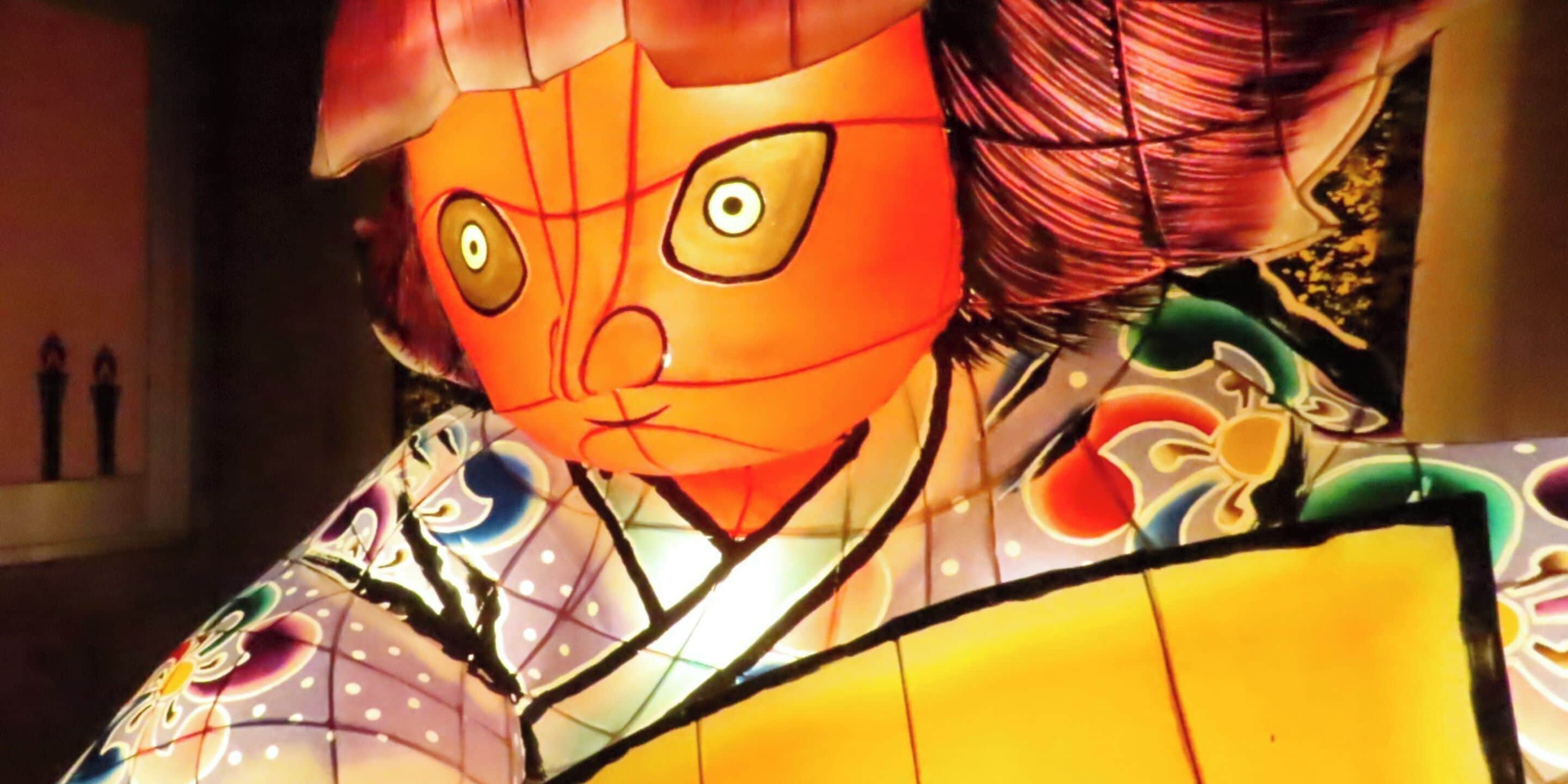 A traditional Japanese lantern with intricate patterns and a face design.