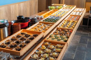 A buffet with various food items arranged in wooden boxes and bowls. - Hotel Resol Trinity Kyoto (Kyoto)