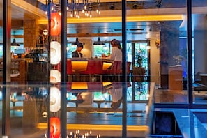 A modern interior with a bar area, reflective floor, and large windows. - Hotel Resol Trinity Kyoto (Kyoto)