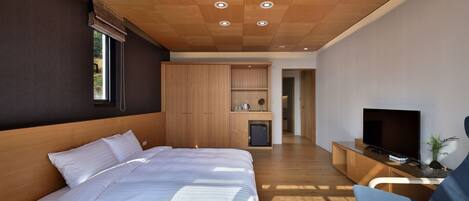 A modern bedroom with a large bed, wooden ceiling, built-in wardrobe, and a TV on a wooden console.