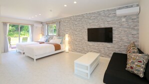 A modern bedroom with two beds, a TV, and a large window. - Stardust Villa Milky Way (Ishigaki)