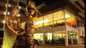 A building with a modern architectural style, featuring large glass windows and a flat roof. - The Singora Hotel (Songkhla)