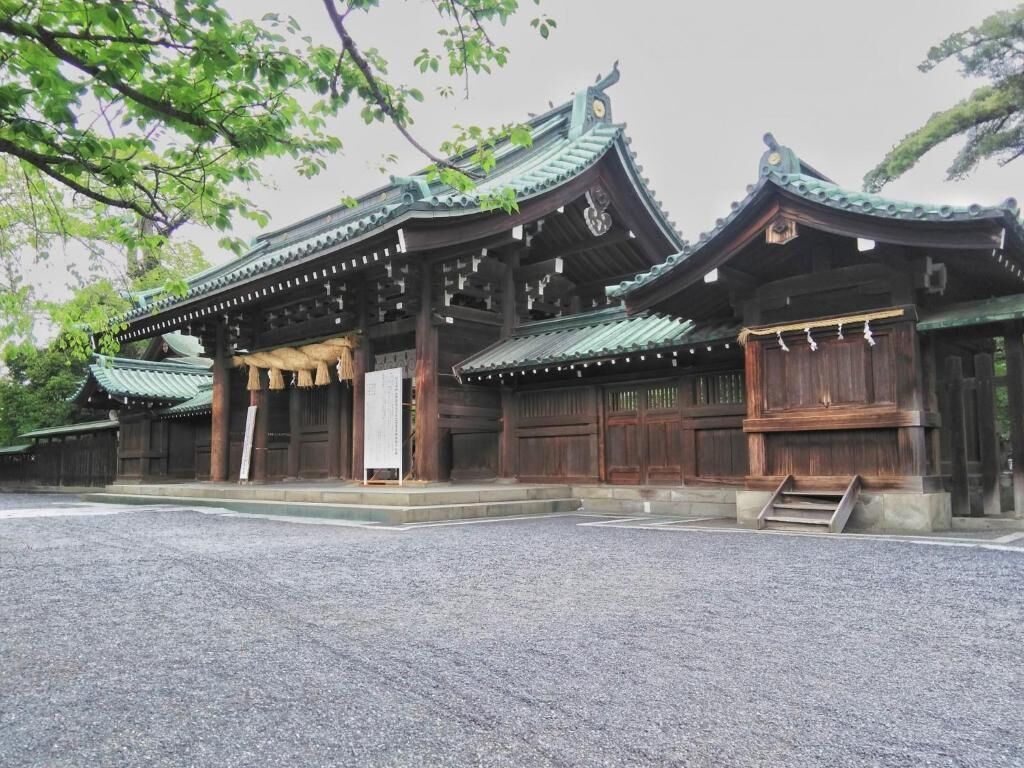 A traditional Japanese building with a tiled roof and wooden structure.