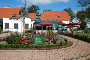 Enjoy a meal or relax in the garden surrounded by vibrant flowers and lush greenery.