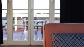 A room with a sliding glass door leading to an outdoor patio area.