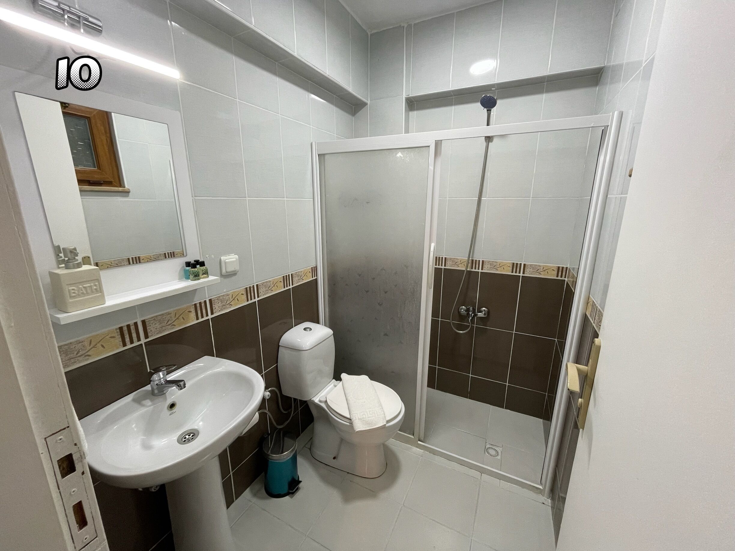 economy double room (basement, no view) | bathroom | shower, free toiletries, hair dryer, slippers
