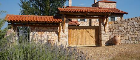 A stone house with a wooden door and a red-tiled roof.