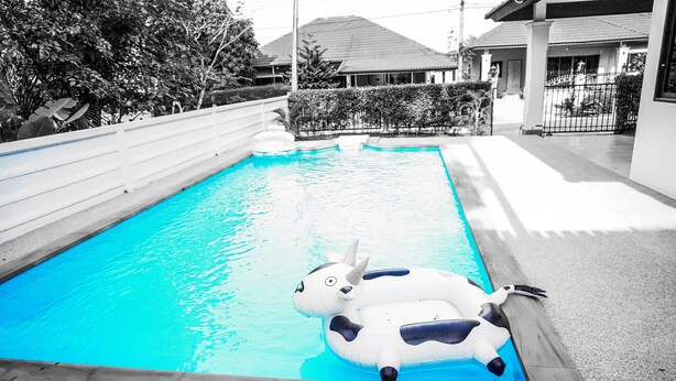 A swimming pool with inflatable animal floats. - Family Villa Iona with Private Pool (Si Sunthon)