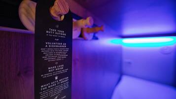 A sign with instructions for volunteers to take their own food and drinks, and to be mindful of noise levels.