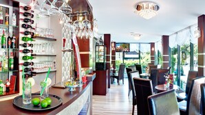 A restaurant with a bar area, seating, and large windows offering a view of the street. - Perelka Kolobrzeg (Kolobrzeg)