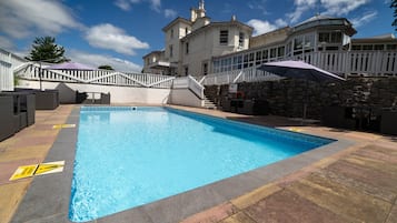 Seasonal outdoor pool, pool umbrellas, pool loungers