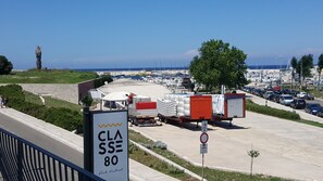 Un puerto deportivo con barcos, un camión y un cartel que indica 'CLASS 80 fish district'.
