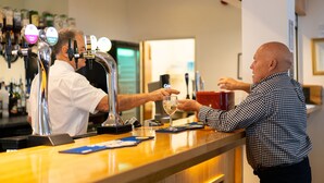 A bar area with multiple taps and a counter.