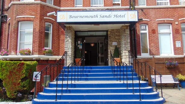 A hotel entrance with a sign reading "Bournemouth Sands Hotel."