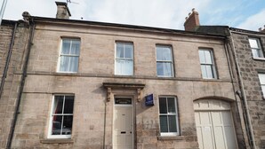 A stone building with a sign reading "Whyteside House" and a smaller sign for "Bed & Breakfast." - The Cowrie Guest House (Berwick-upon-Tweed)