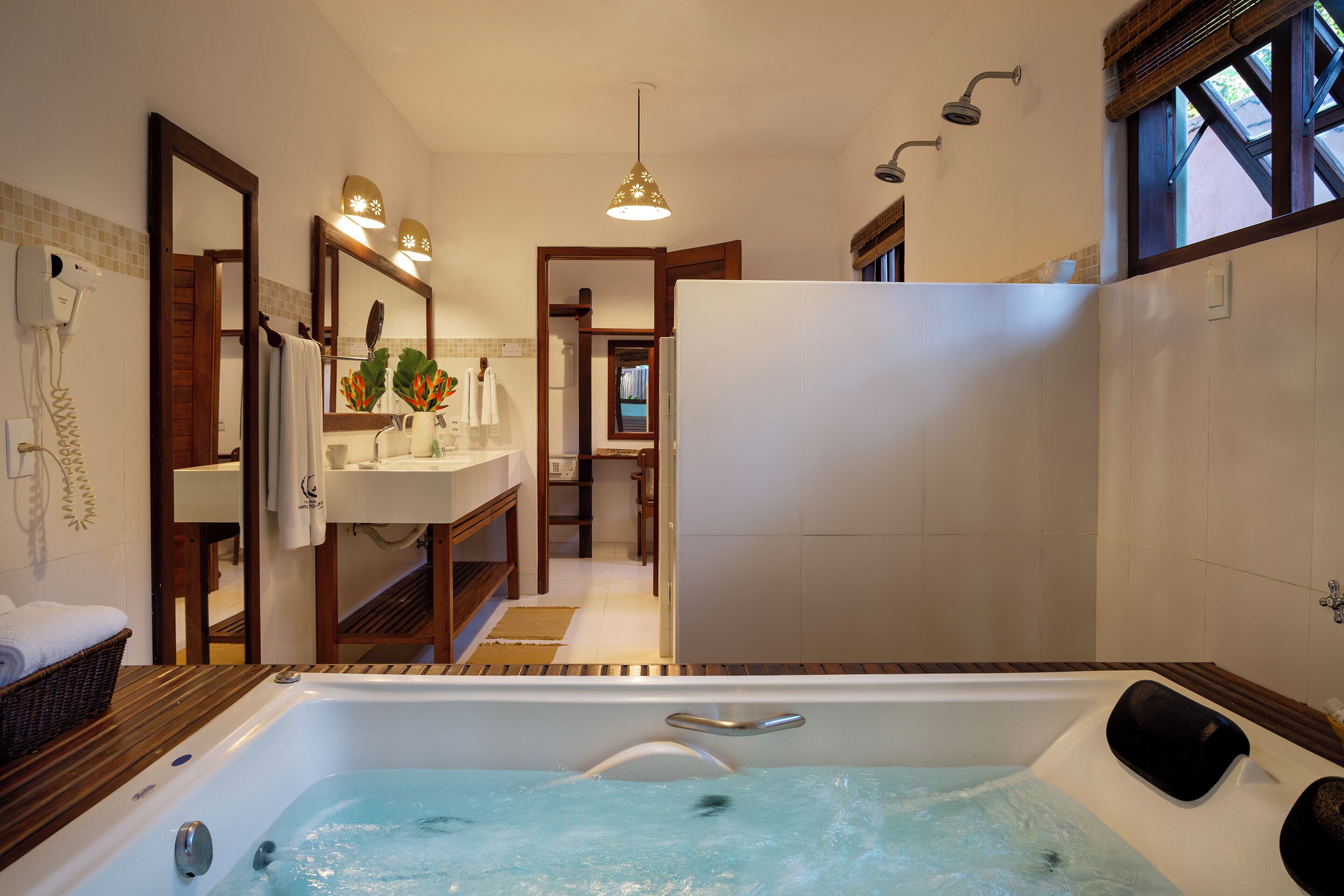 A modern bathroom with a bathtub, a shower, and a sink.