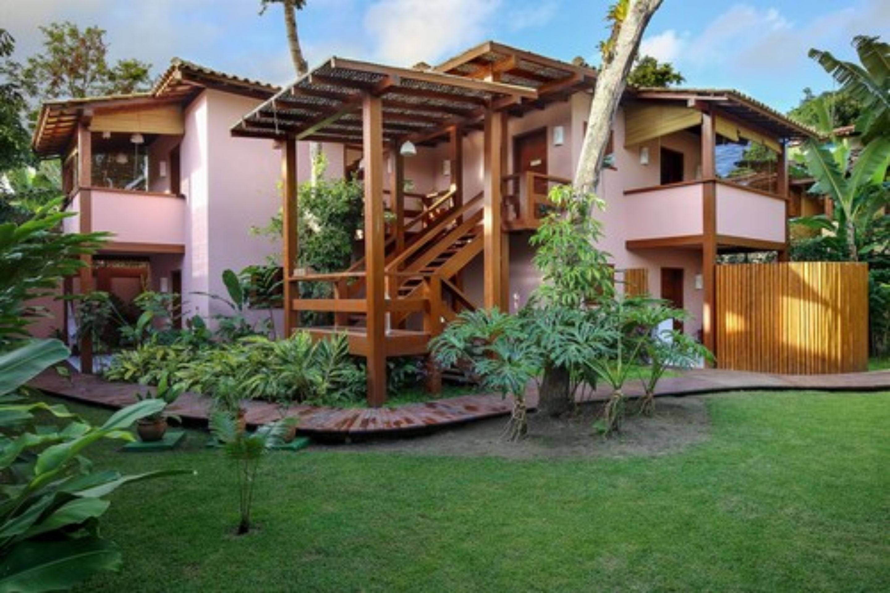 A two-story building with a wooden staircase leading to a balcony.