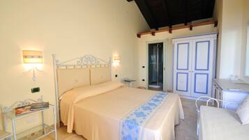 A bedroom with a bed, bedside tables, a wardrobe, and a bathroom door.