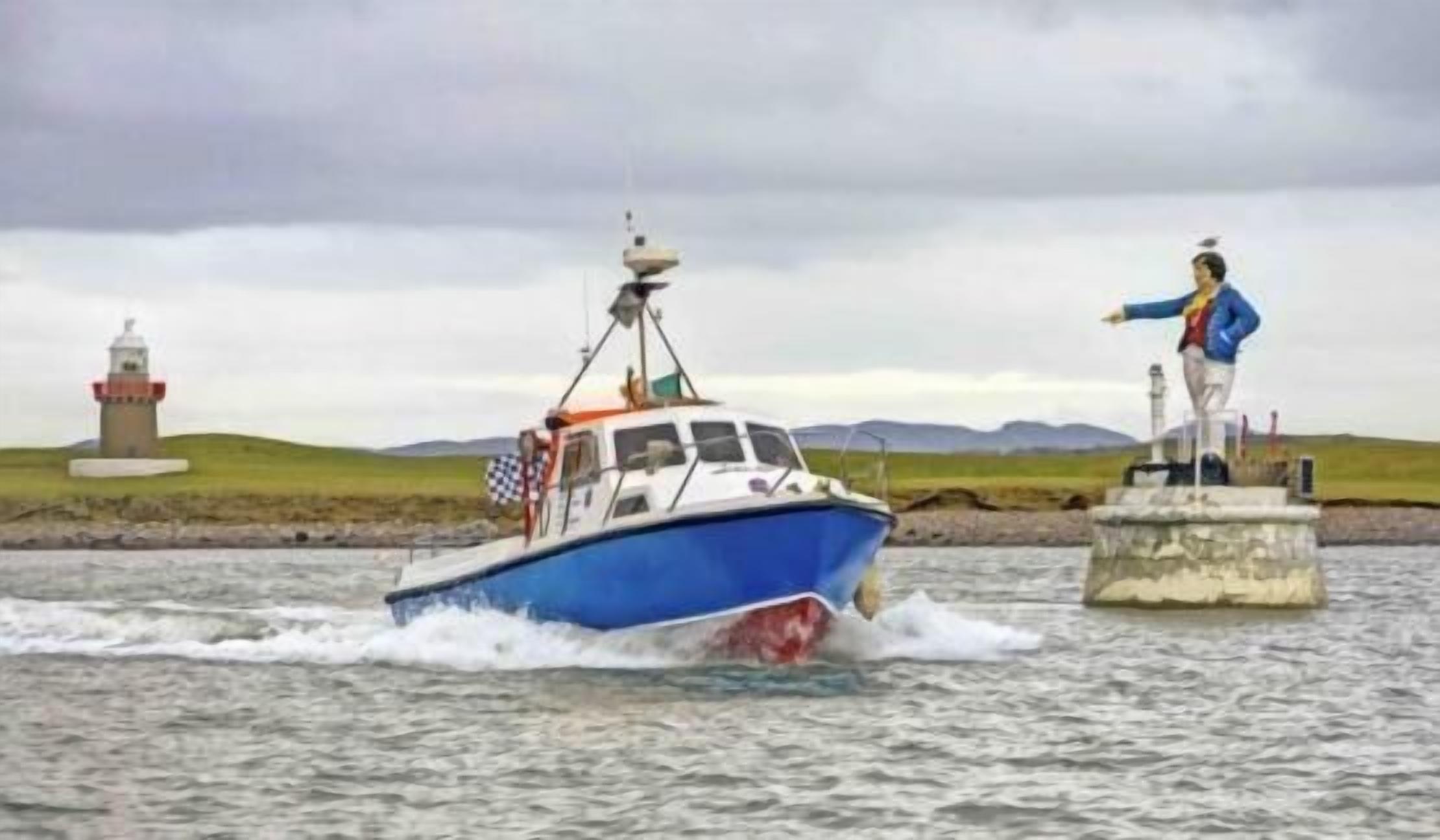 A blue boat with a lighthouse in the background.