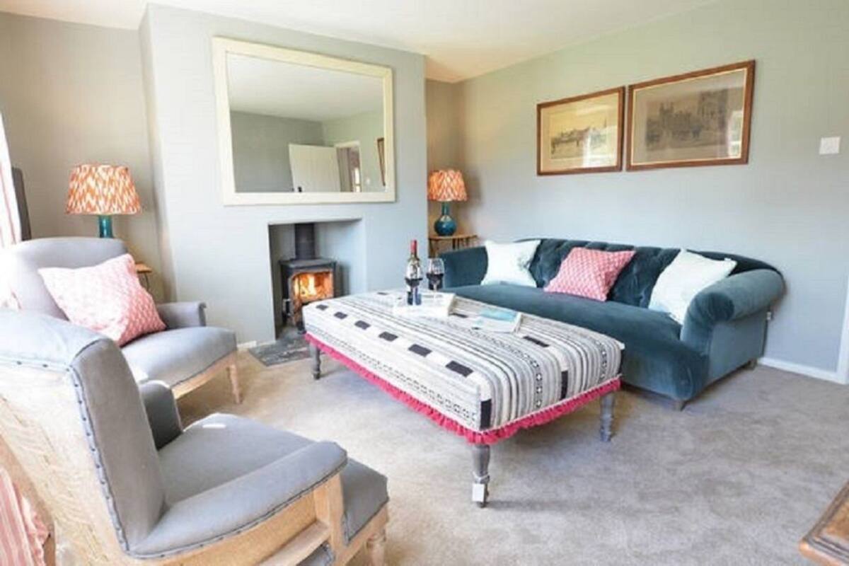 A living room with a fireplace, a sofa, a chair, and a coffee table.