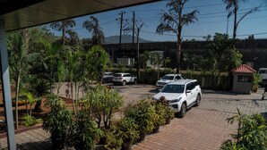 A parking area with several cars and potted plants. - Royal Hills Vasai - Thane (Vasai)