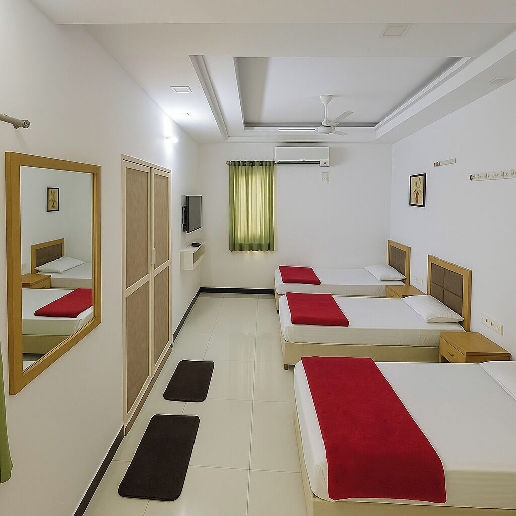 Habitación de hotel con dos camas individuales, un armario, un televisor y un ventilador de techo.