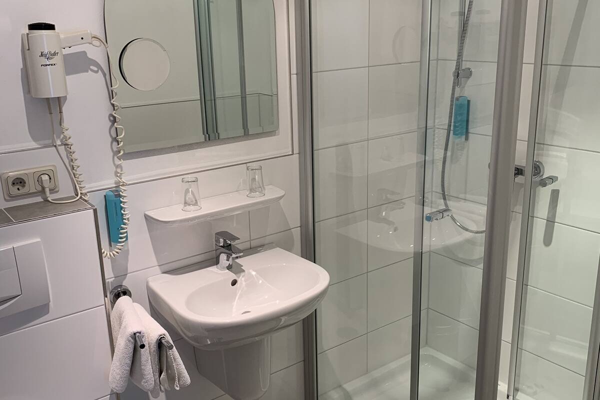 shower, hair dryer, towels, soap