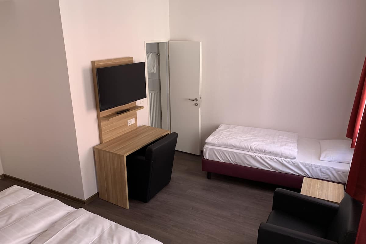 basic triple room | hypo-allergenic bedding, desk, blackout curtains, free cots/infant beds