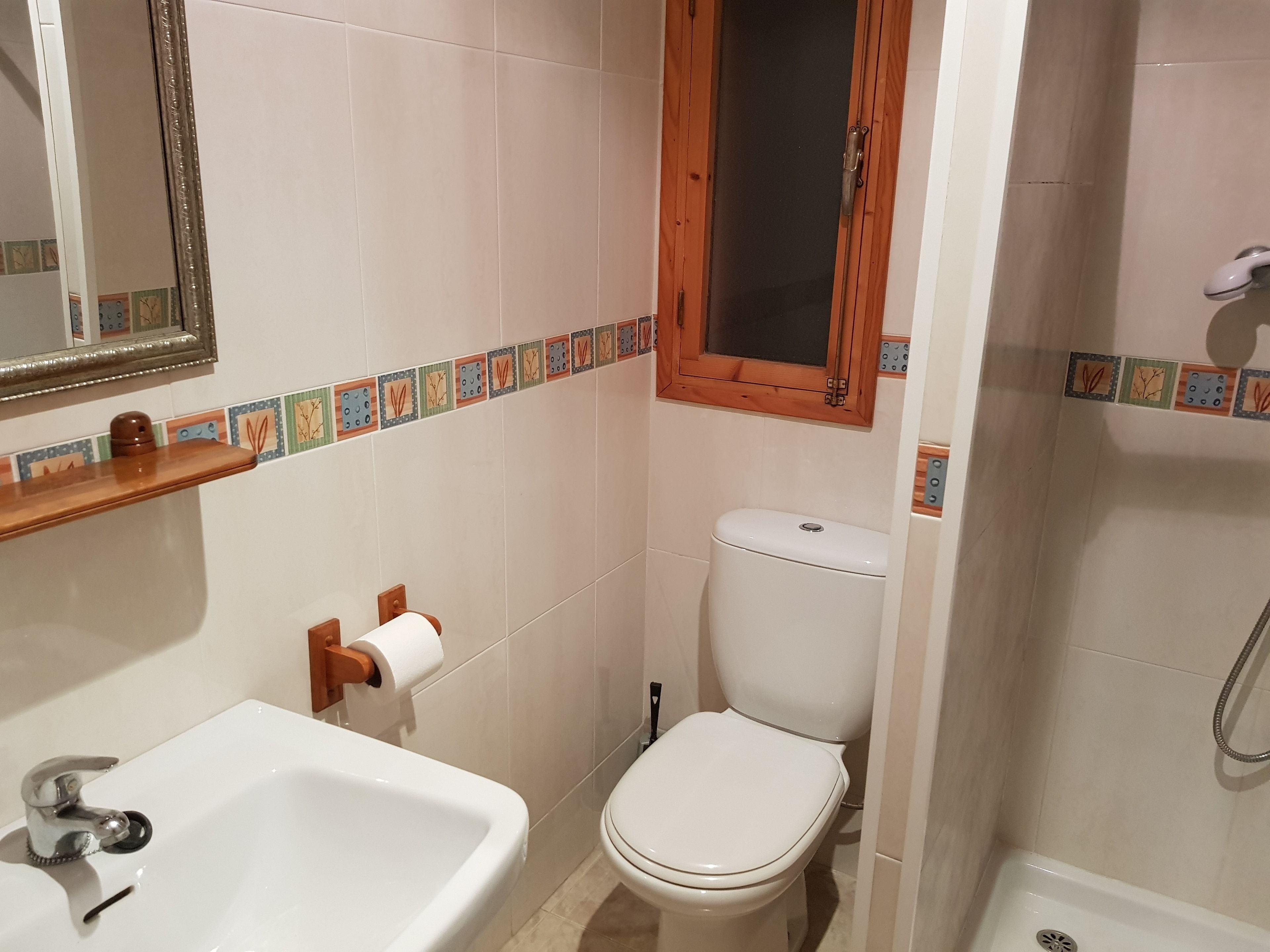 A bathroom with a sink, toilet, and shower.