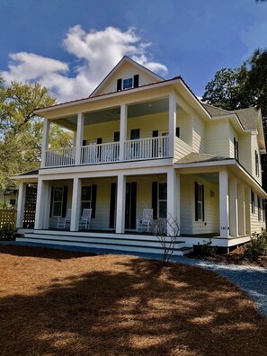A two-story house with a porch and a balcony.