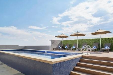 Outdoor pool, open 8:00 AM to 10:00 PM, pool umbrellas, sun loungers