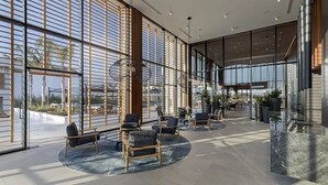 A spacious lobby with large windows, modern seating, and a reception area. - D Andrea Lagoon All Suites - Adults only (Kos)
