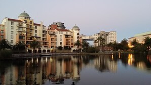 A waterfront hotel with multiple buildings, balconies, and a reflection in the water. - Luxurious Apartment in Century City (Cape Town)