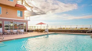 A swimming pool with lounge chairs and a view of the beach. - WorldMark Blaine (Blaine)