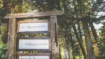A wooden signpost with directional arrows and text indicating locations.