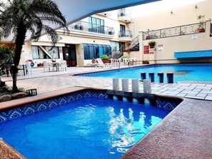 Outdoor pool, open 7:00 AM to 10:30 PM, pool loungers