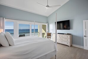 A bedroom with a large bed, a TV mounted on the wall, a dresser, and a balcony with a view of the ocean. - Splash in the water, play in the sand, REJUVENATE! 205- Destin Seafarer (Destin)