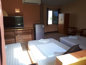 A hotel room with two beds, a TV, a refrigerator, a desk, and a wardrobe. - Phoemphoon 2 Hotel (Nan)