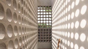 A staircase with circular cutouts on the walls, leading to a covered area with a bamboo ceiling. - Atelier TE Designer Guesthouse (Denpasar)