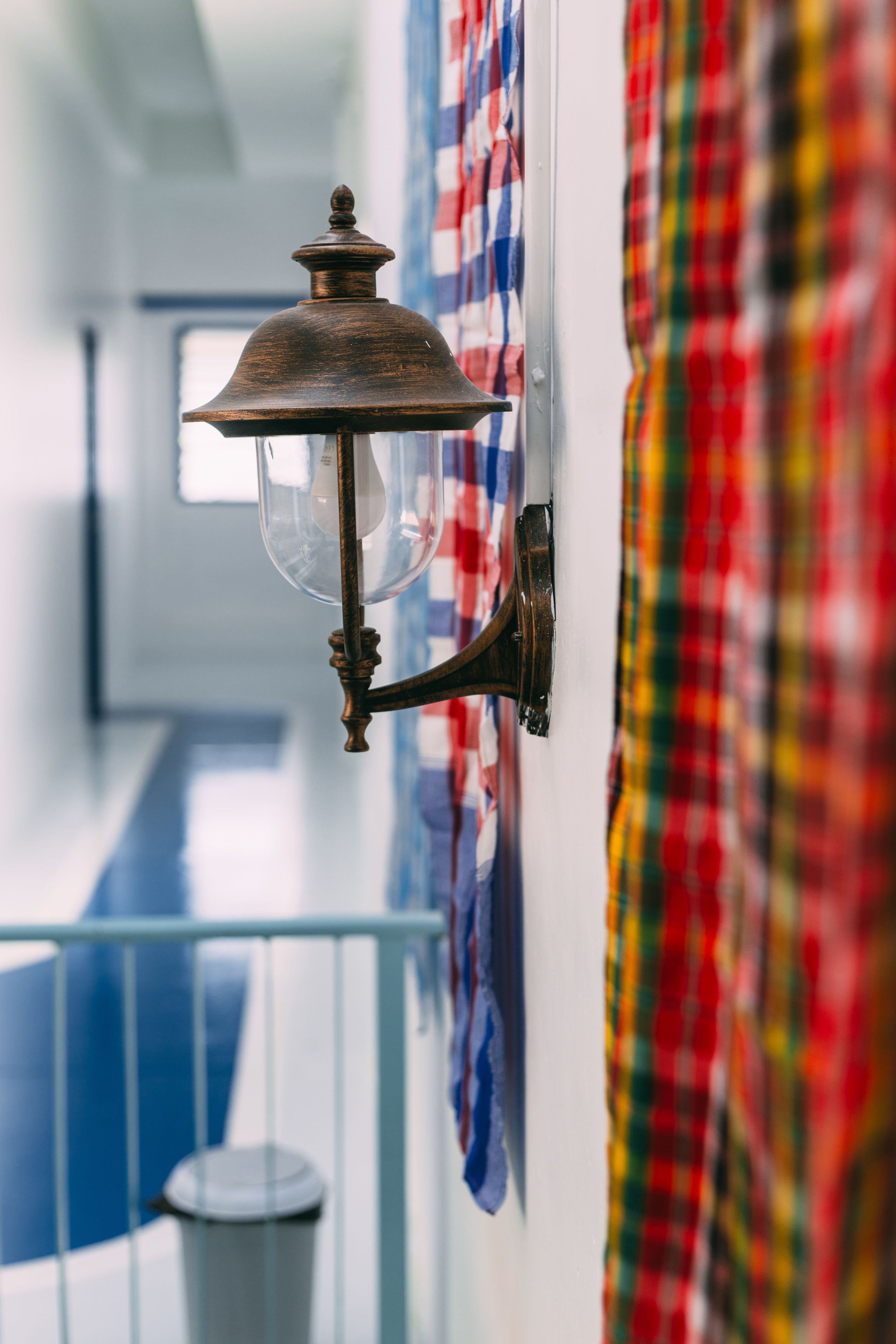 A wall-mounted light fixture with a clear glass shade and a metal base.