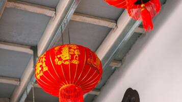 A ceiling with metal beams and red lanterns hanging from it.