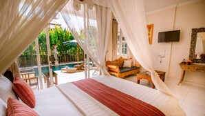 A bedroom with a bed, a TV, a bedside table, and a view of an outdoor swimming pool. - Sekembang Ubud Villa (Ubud)