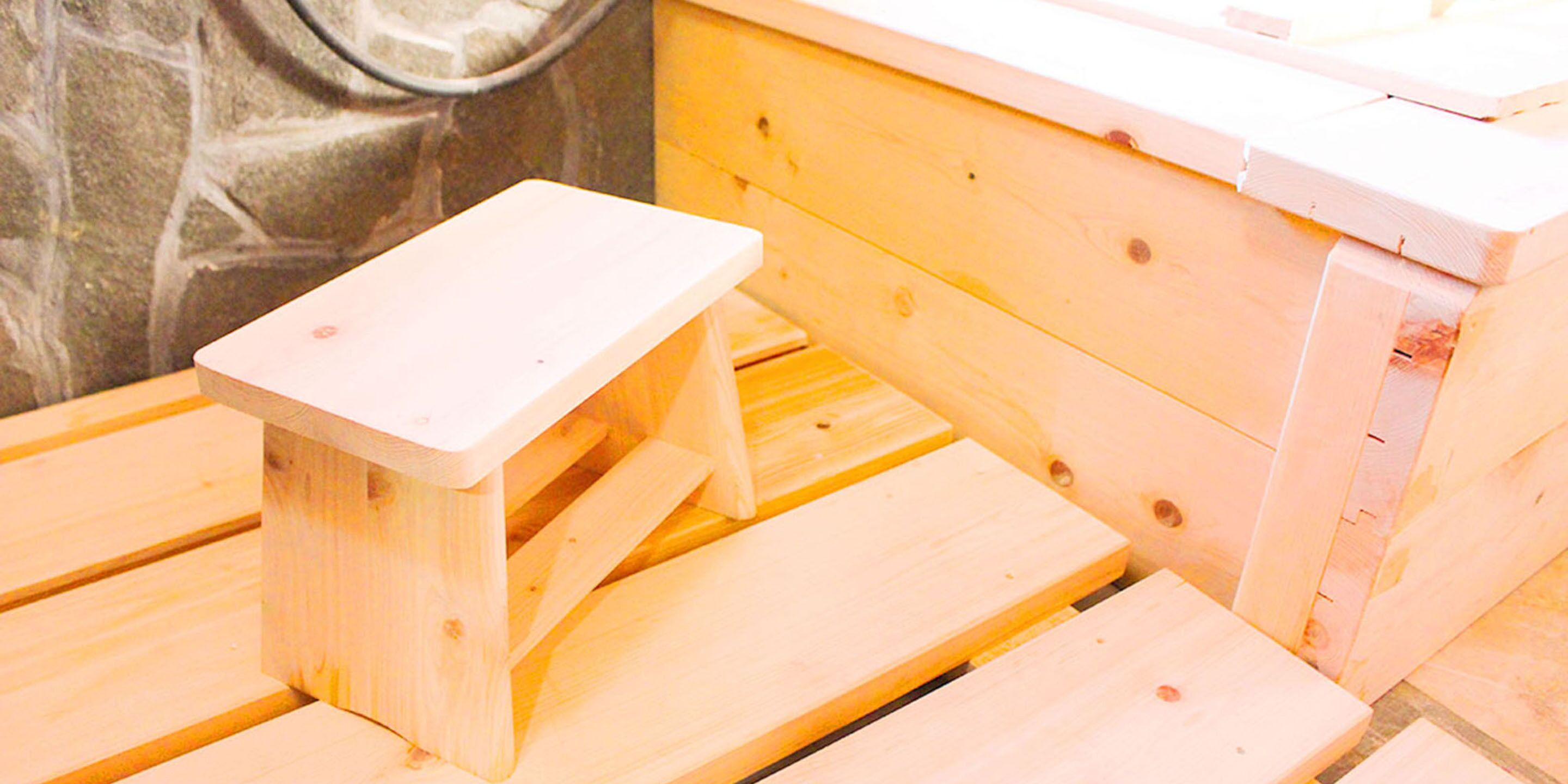 A wooden bench with a small table attached to it.